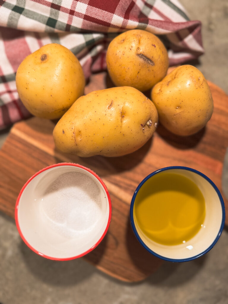 a group of potatoes and a cup of oil