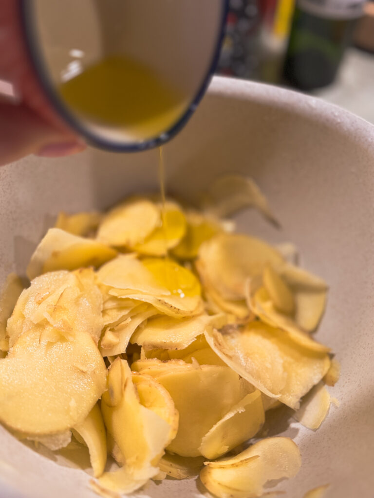 a bowl of food with a person pouring oil