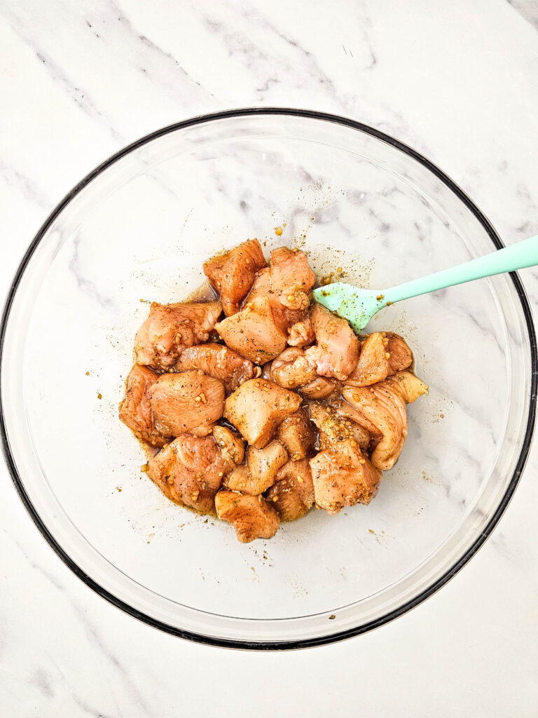 Chicken tossed in marinade until evenly coated.
